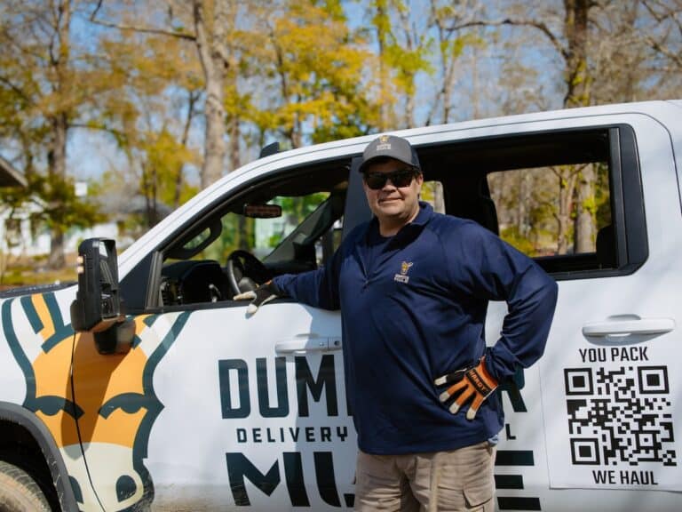 Ted Dunn posing with Dumpster Mule truck